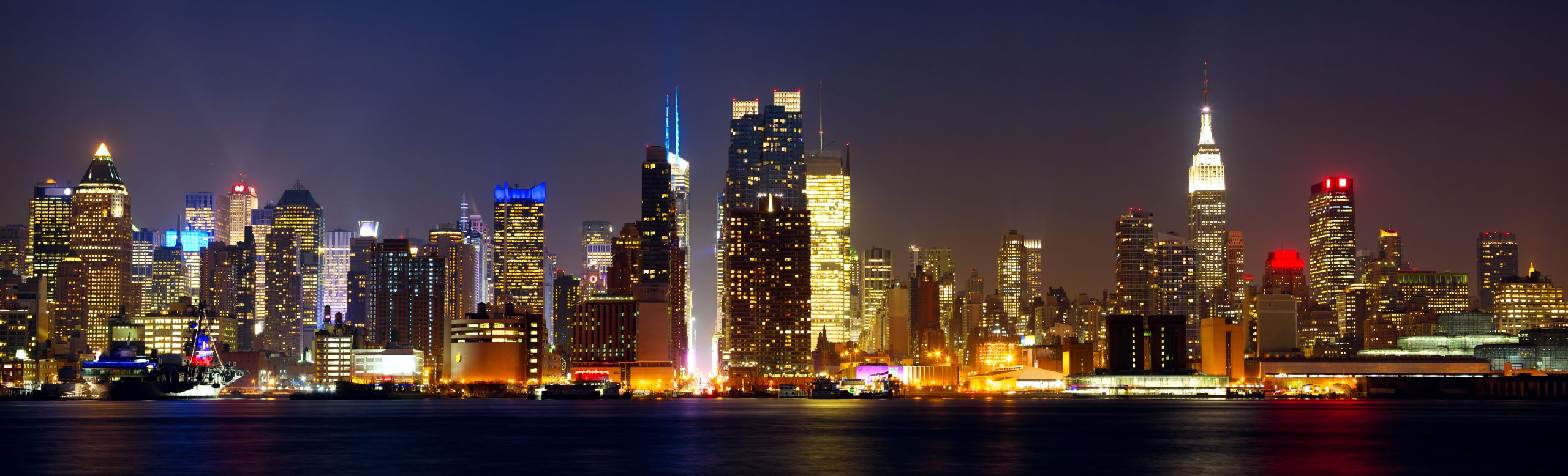 Manhattan skyline panorama with Times Square lights at night, New York City